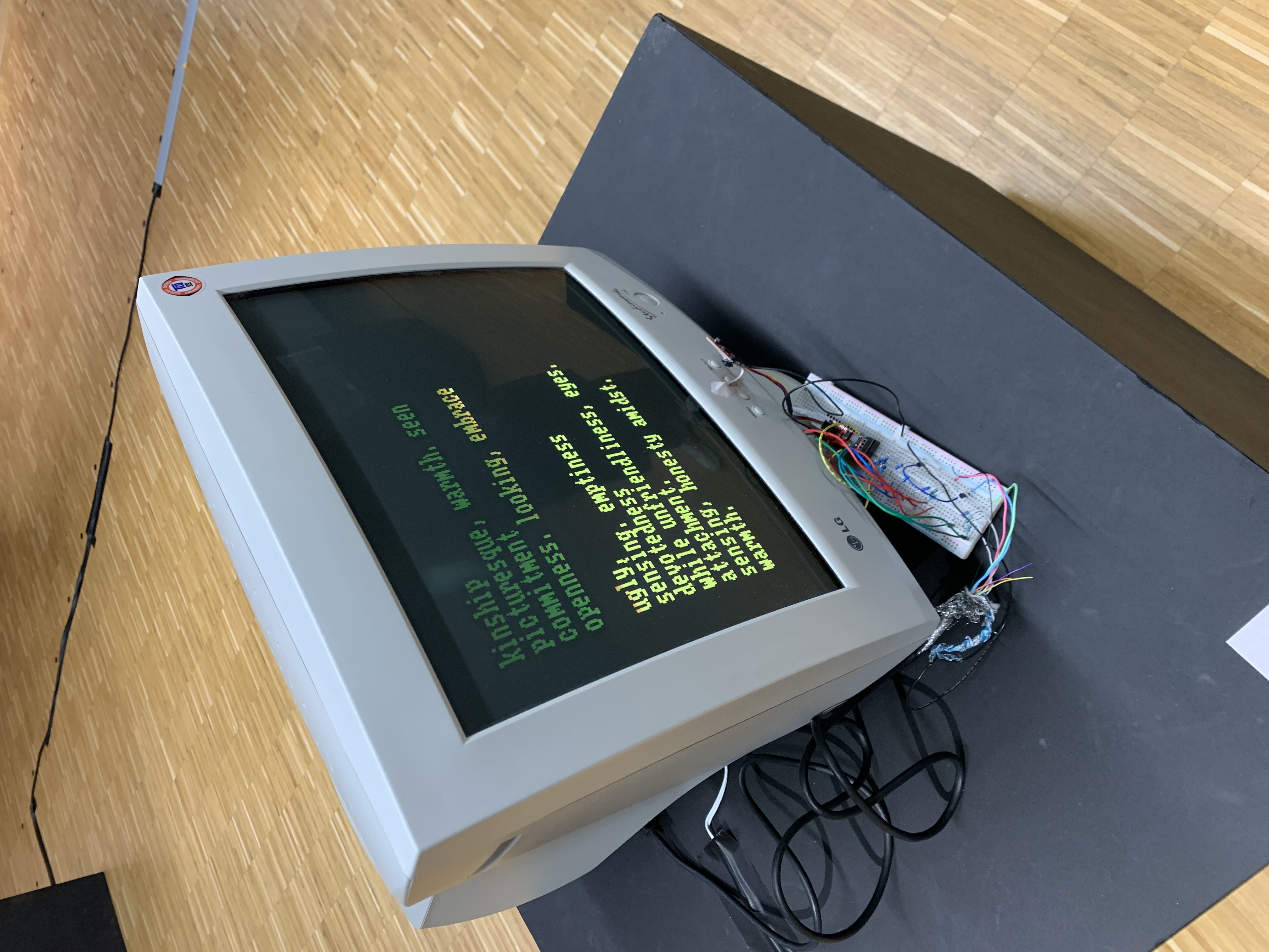 A picture of the work, showing a poem on a CRT display